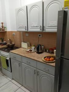 a kitchen with a stove and a plate of fruit on the counter at Nile River Bed and Breakfast in Luxor