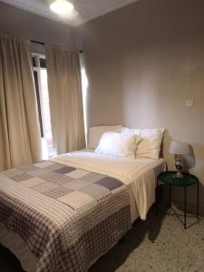 a bedroom with a bed and a lamp on a table at Ibex Hill apartment in Lusaka