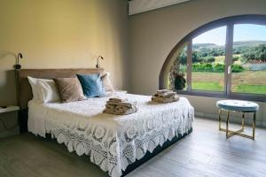 ein Schlafzimmer mit einem Bett und einem großen Fenster in der Unterkunft Judeka Agriresort in Caltagirone