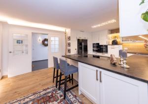 a kitchen with white cabinets and a counter top at Chalet "Villa Marlene" in Zell am See +23 photos
