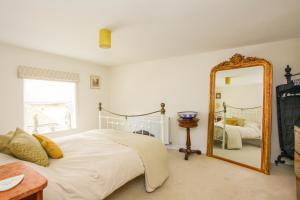 a bedroom with a bed and a mirror at Newgate House, Sandwich in Sandwich +4 photos