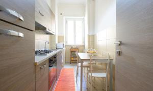 a small kitchen with a table and chairs in it at PeoniaMaximaHouse -Piazza Bologna- in Rome