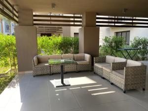 a patio with couches and a table in a building at Marassi Marina Residences in El Alamein