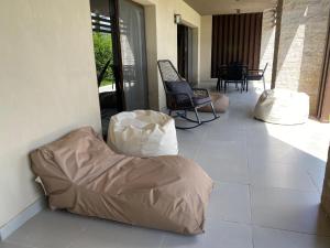 a porch with a bean bag chair and a table at Marassi Marina Residences in El Alamein