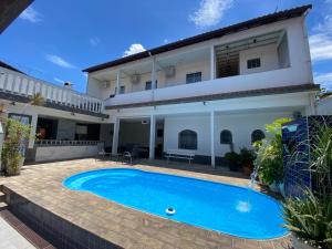 a swimming pool in front of a house at Casa R2, com piscina a 04 Km do Parque Olímpico in Rio de Janeiro