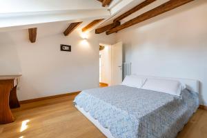 a white bedroom with a bed and a wooden floor at Clock's 2 bedrms 2 baths big terrace loc13324 in Venice-Lido