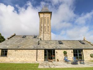 a building with a clock tower on top of it at Tower Barn Cottage in Ryde