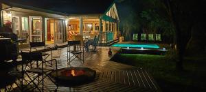 a backyard with a fire pit next to a house at Thornwood in Hluhluwe