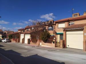 a row of houses with white garage doors on a street at Room in Chalet - Private Double Room Toledo in Toledo