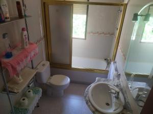 a bathroom with a sink and a toilet and a window at Room in Chalet - Private Double Room Toledo in Toledo