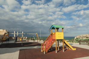 a playground with a slide in front of the ocean at A52 - Apartment with Sea and Country Views in Mellieħa