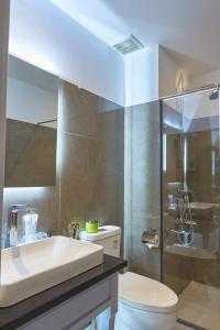 a bathroom with a sink and a toilet and a shower at The Alcove Apartment Vung Tau in Vung Tau