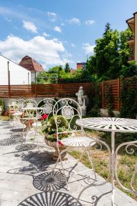 a group of chairs and tables on a patio at Ateneea Luxury Rooms in Cluj-Napoca