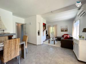 a living room with a couch and a table at Villa Gaïa in Sainte-Maxime