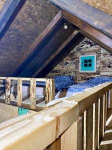 Schlafzimmer mit einem Bett auf einem Holzbalkon in der Unterkunft Cottages of Nišići in Sarajevo