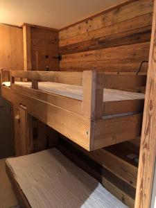 two wooden bunk beds in a room at Tignes : cocon luxueux au pied des pistes in Tignes
