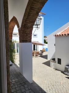 a view of the courtyard of a house with white buildings at Solar de Arrayollos Charming House in Arraiolos