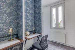 Habitación con papel pintado azul, escritorio y silla en Modern House 7min to Paris Professionals and Family, en Alfortville