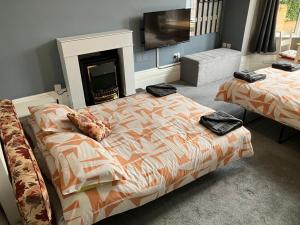 a bedroom with two beds and a fireplace at Well-appointed apartment in New Brighton in New Brighton
