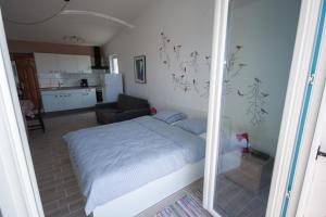 a small bedroom with a bed and a kitchen at Apartment Mikuš in Stinica