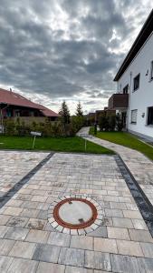 a brick courtyard with a man hole in the middle at Ferienwohnung Wiesenweg in Seeg