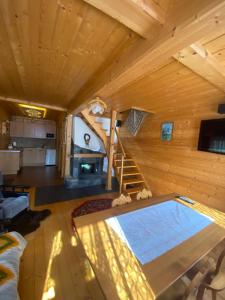 a log cabin with a swimming pool in a living room at Domek w górach in Nowy Targ