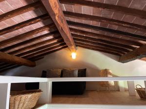 a room with a white table and wooden ceilings at Appartamento centro storico La Pulcianella con vista in Montepulciano