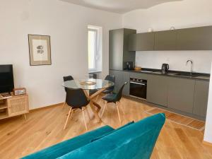 a kitchen and dining room with a table and chairs at La Casetta in Carrù +15 photos