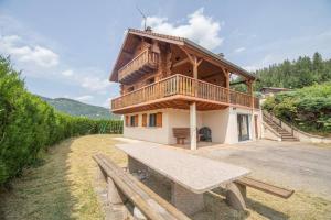 a wooden house with a bench in front of it at F'amis Lodge, 10 à 20p et sauna in Cornimont