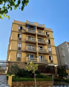 um edifício amarelo alto com varandas em APTO 14 - ENSEADA, PRÓXIMO REGIÃO DO PÃO DE AÇUCAR no Guarujá mais 21 fotografias