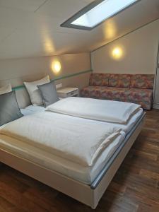 - une chambre avec un grand lit et un canapé dans l'établissement Haus Monika, à Oetz