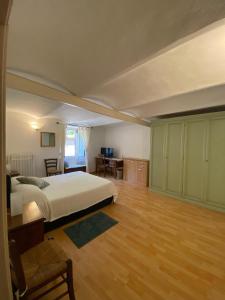 a bedroom with a bed and a desk in it at Da Nonna Puni in Orvieto