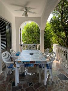 a table and chairs on a porch with a window at Pag Vlasici in Vlašići +41 photos