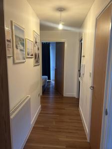 a room with a hallway with at Immaculate 2-Bed Apartment in Romford in Romford