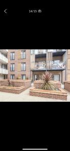 two photographs of a building with two benches at Immaculate 2-Bed Apartment in Romford in Romford