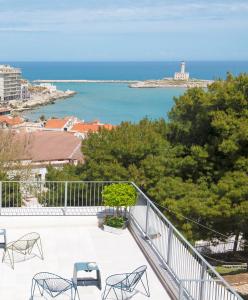 a balcony with chairs and a view of the ocean at Dimora Cummà Marì in Vieste