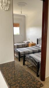 two beds in a room with a mirror at Appartements Armonía Sea View in Briech