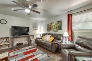 a living room with leather furniture and a flat screen tv at Cozy Norman Home 4 Mi to Oklahoma University! in Norman