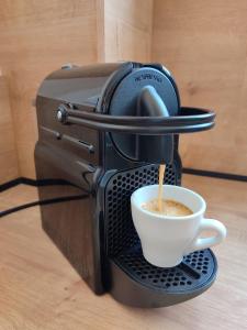 a coffee maker is making a cup of coffee at Orfhl Studio in Missolonghi