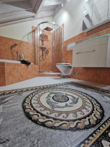 a bathroom with a mosaic tile floor with a shower and a sink at Ferienwohnung Sonnenschein in Rieden am Forggensee +44 photos