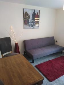 a living room with a couch and a table at 124A Castle Street Hinckley in Hinckley