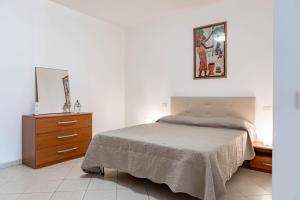 een slaapkamer met een bed, een dressoir en een spiegel bij H11 [Bussana 2A] Mare in Bussana Nuova
