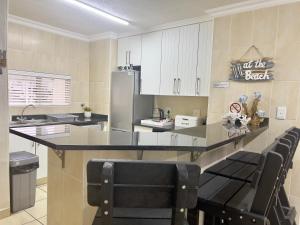 a kitchen with a counter and a refrigerator at 196 Laguna La Crete in Uvongo Beach