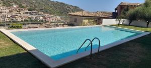 a large swimming pool in the backyard of a house at Villasimius Appartamento "Il Ginepro" in Villasimius