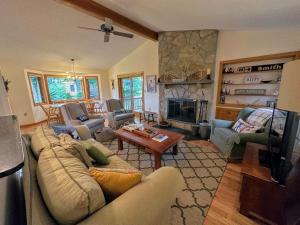 a living room with a couch and a fireplace at FC54 large mountain cottage with views in Bretton Woods