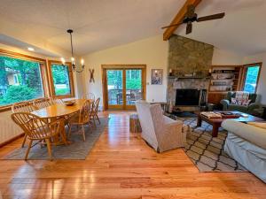 a living room with a table and a couch at FC54 large mountain cottage with views in Bretton Woods