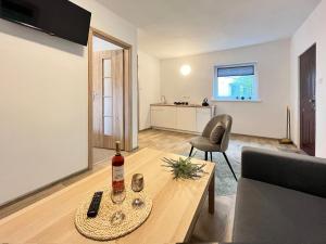 a living room with a couch and a table at Domek Letniskowy Soluch in Rewal +12 photos