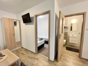 a room with a door leading to a bedroom at Domek Letniskowy Soluch in Rewal