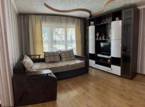 a large living room with a couch and a television at Садиба Файна Гофа in Verkhovyna
