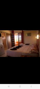 a bedroom with a large bed in a room at Casa do Jardim in Canoa Quebrada